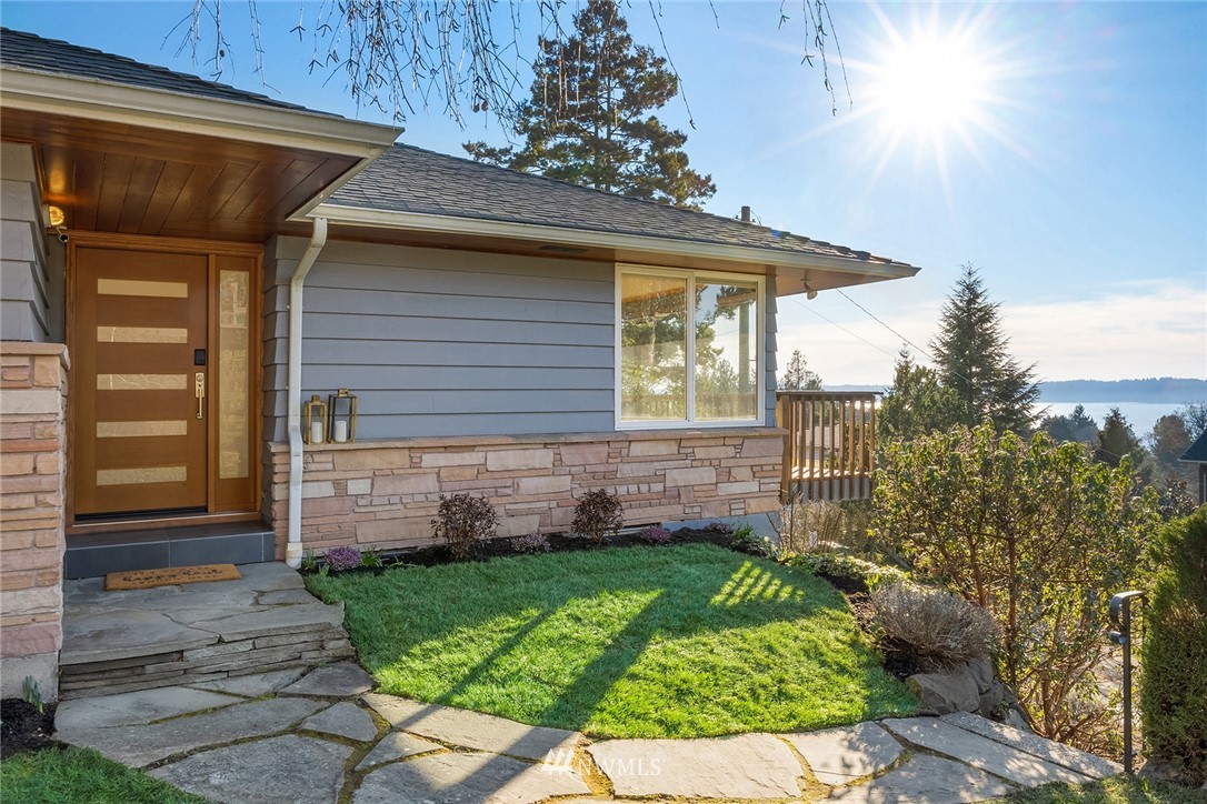 8750 Fauntlee Crest Southwest Seattle, WA 98136 - Photo 2 of 40 a front view of a house with garden