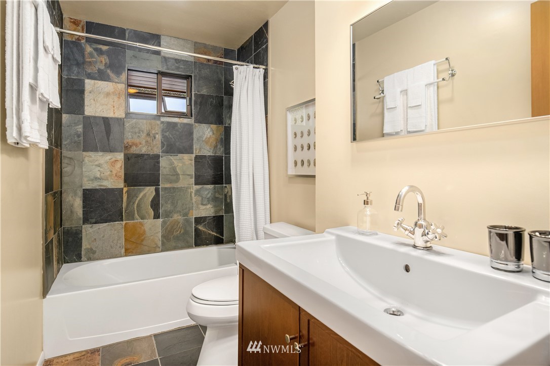 8750 Fauntlee Crest Southwest Seattle, WA 98136 - Photo 23 of 40 a bathroom with a sink toilet and shower