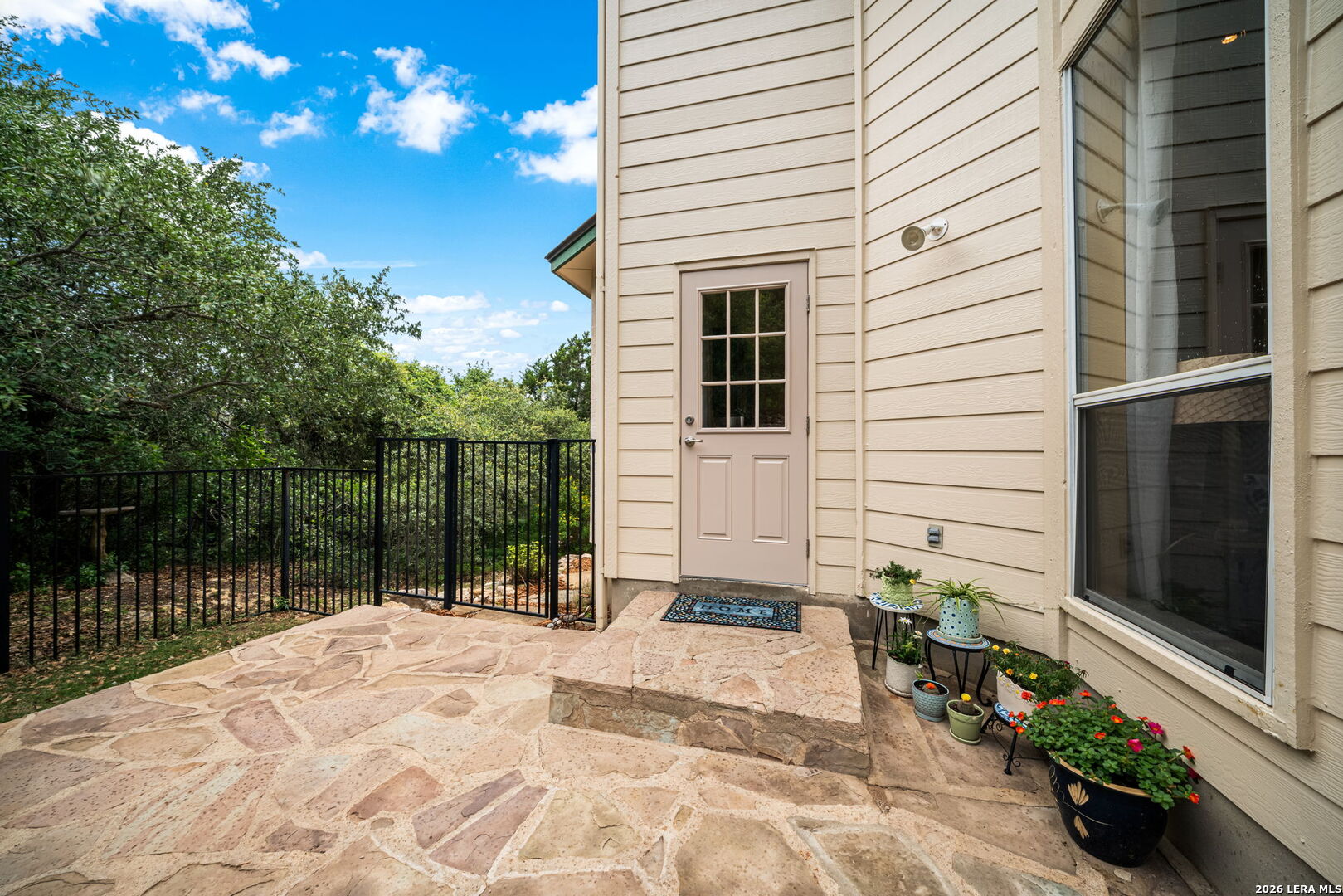 17431 Helotes Spring Road Helotes, TX 78023 - Photo 40 of 50 a balcony with a potted plant and floor to ceiling window