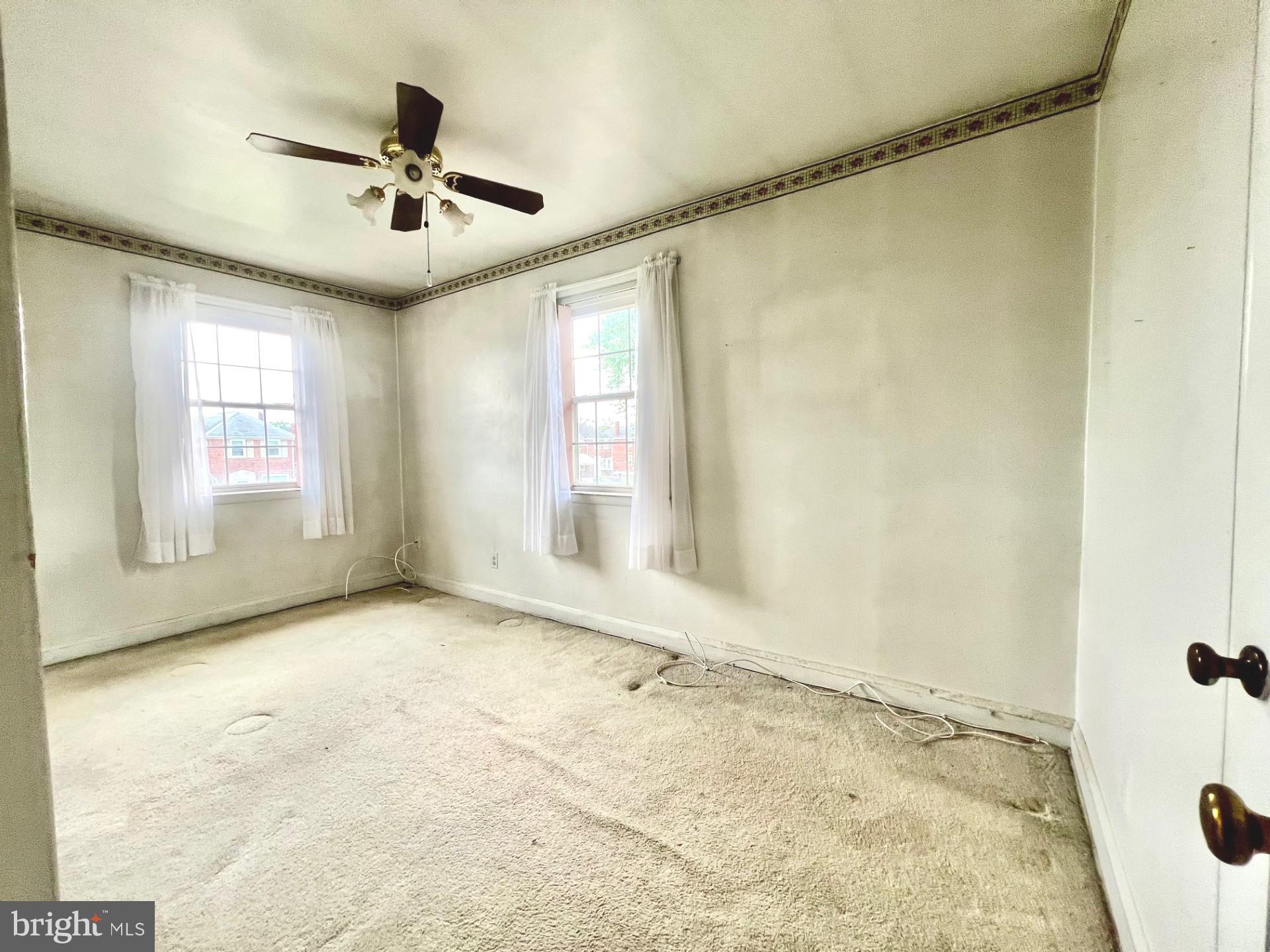 2801 Southbrook Road Baltimore, MD 21222 - Photo 12 of 26 a view of a livingroom with a window and a ceiling fan