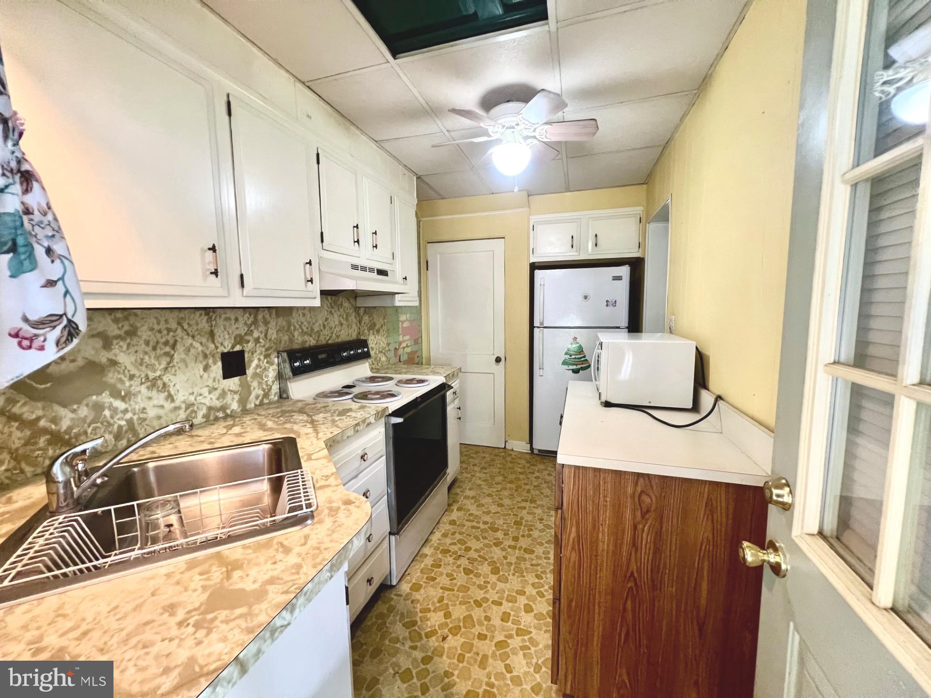 2801 Southbrook Road Baltimore, MD 21222 - Photo 4 of 26 a kitchen with stainless steel appliances granite countertop a sink stove and refrigerator
