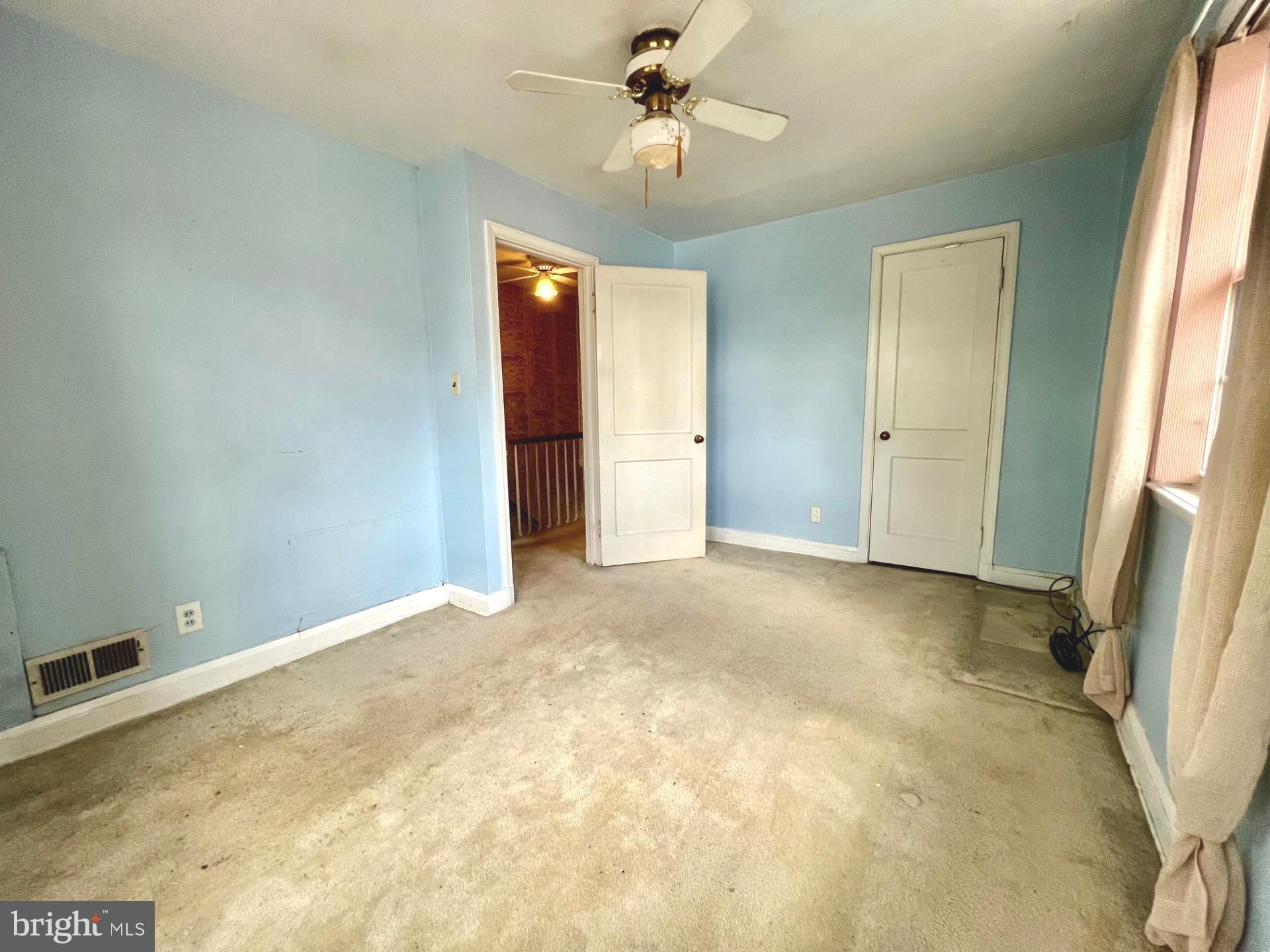2801 Southbrook Road Baltimore, MD 21222 - Photo 9 of 26 an empty room with a ceiling fan and a window