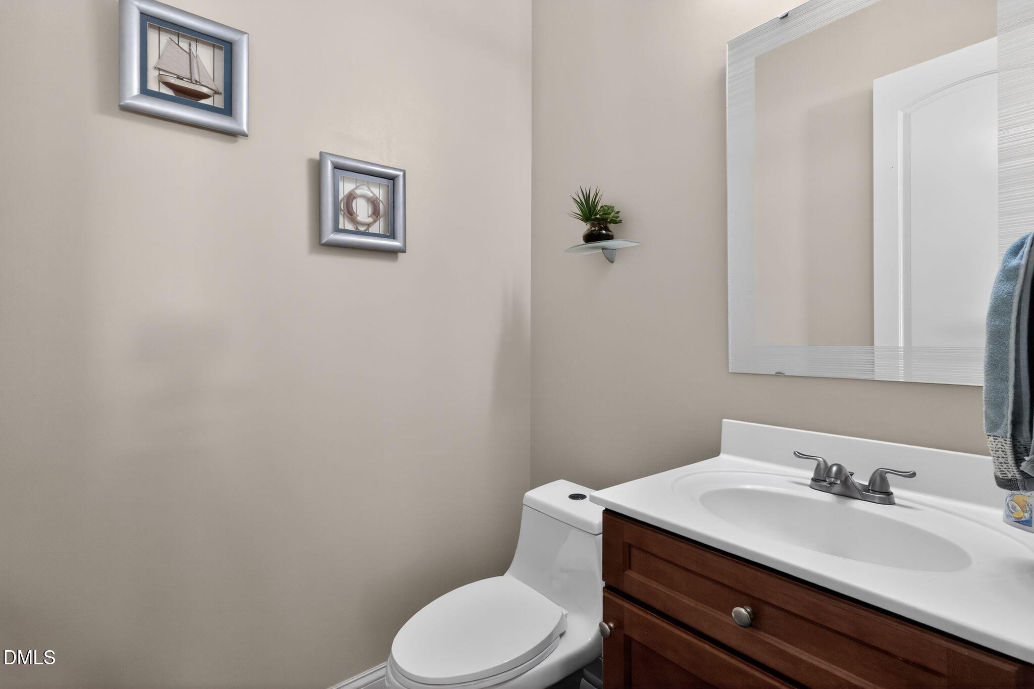 3428 Massey Pond Trail Raleigh, NC 27616 - Photo 14 of 39 a bathroom with a granite countertop toilet sink and mirror