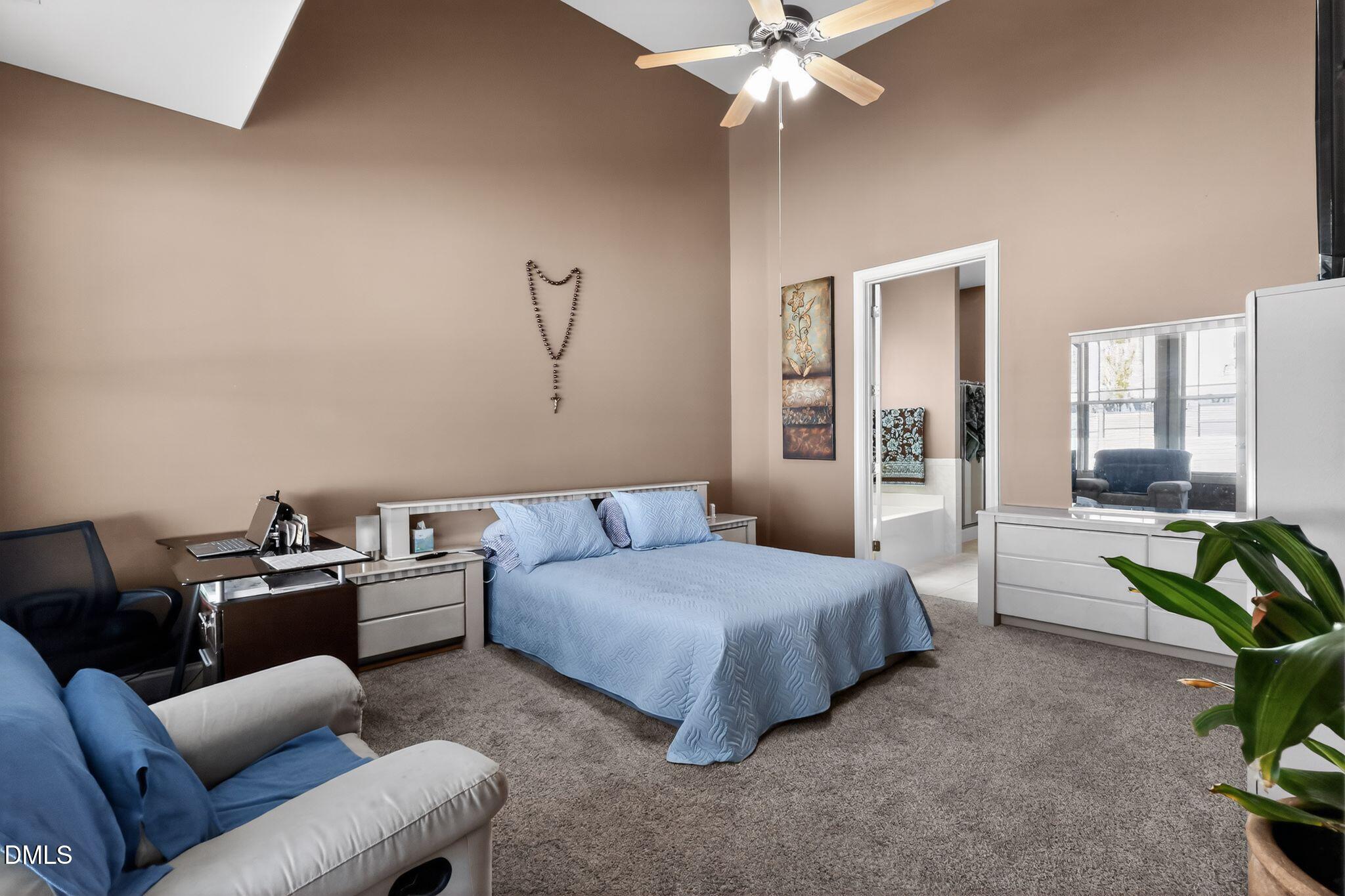 3428 Massey Pond Trail Raleigh, NC 27616 - Photo 16 of 39 a bedroom with a bed and a chandelier