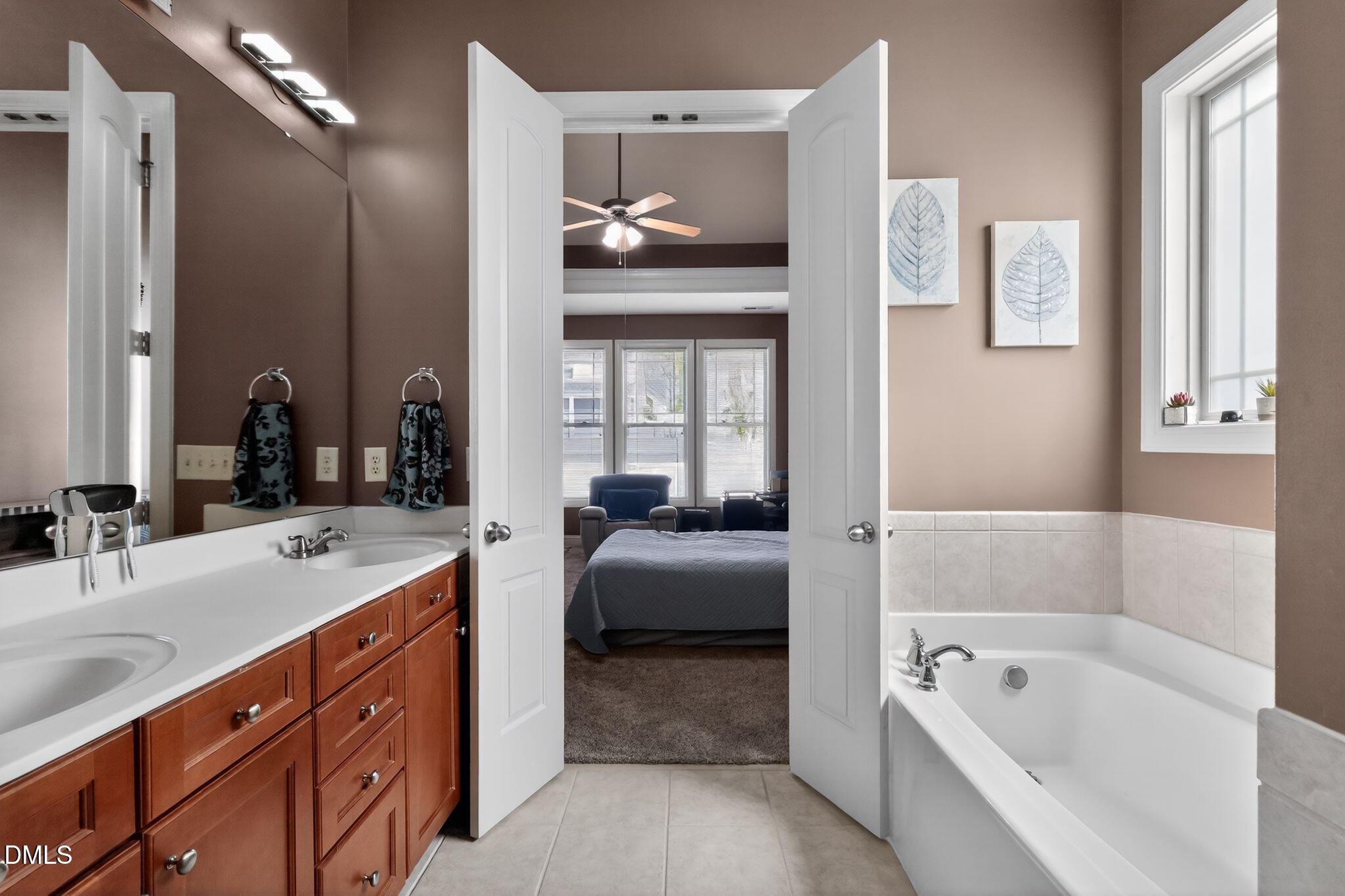 3428 Massey Pond Trail Raleigh, NC 27616 - Photo 18 of 39 a en suite spacious bathroom with a tub double vanity and a mirror