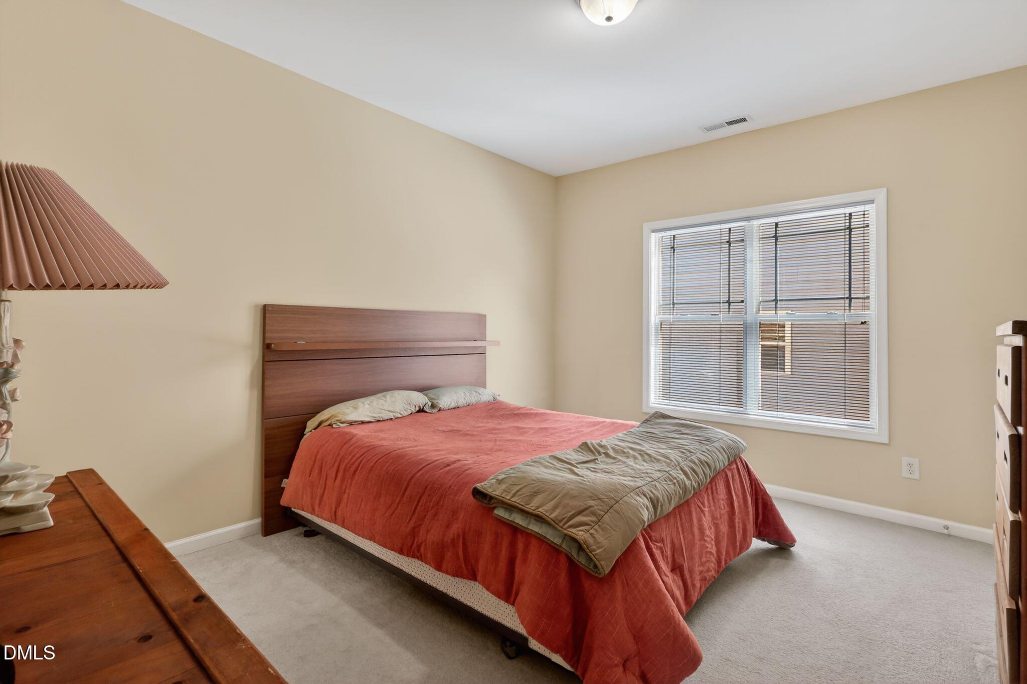 3428 Massey Pond Trail Raleigh, NC 27616 - Photo 24 of 39 a bedroom with a bed and a window