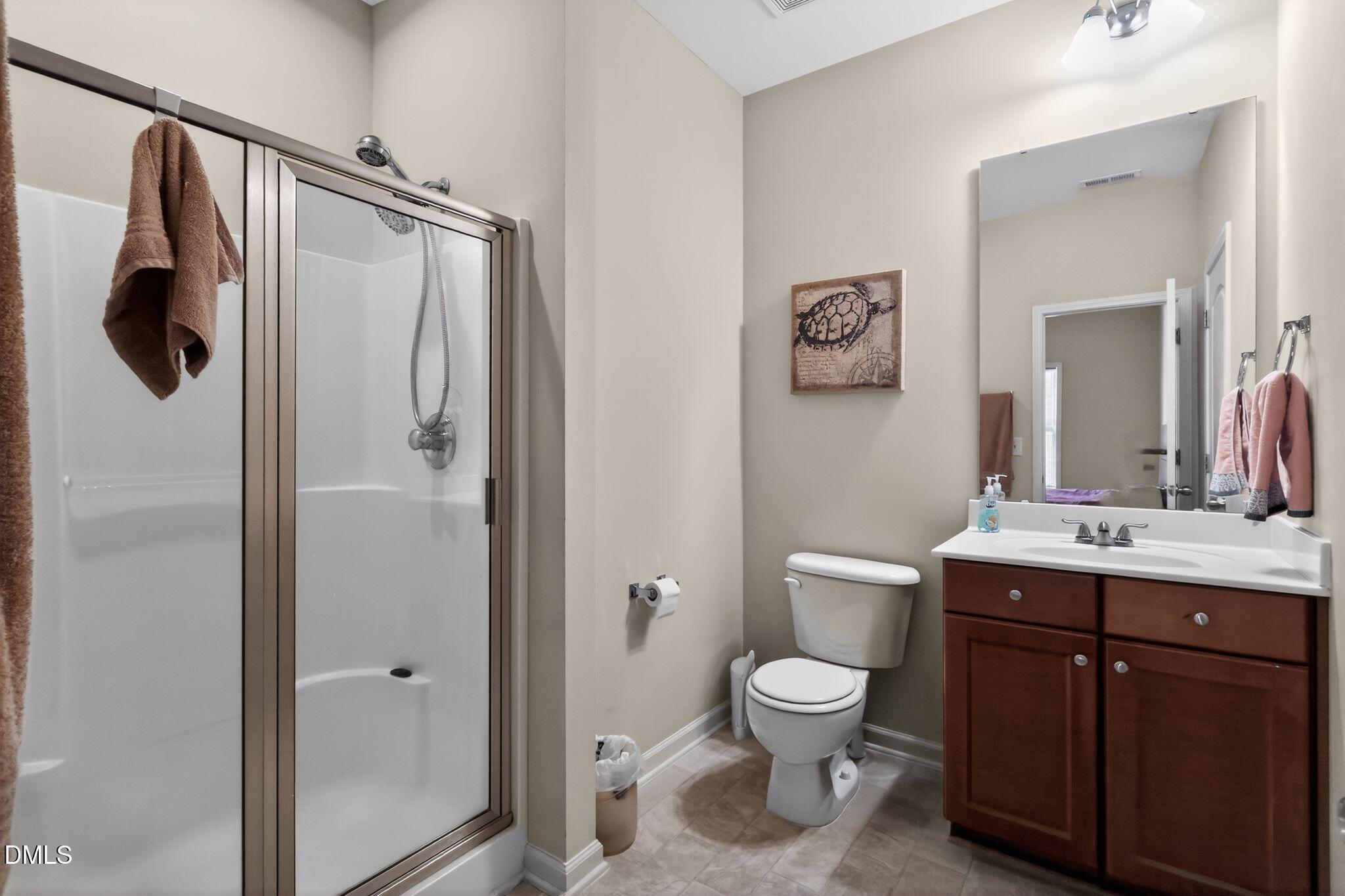 3428 Massey Pond Trail Raleigh, NC 27616 - Photo 25 of 39 a bathroom with a toilet sink and mirror