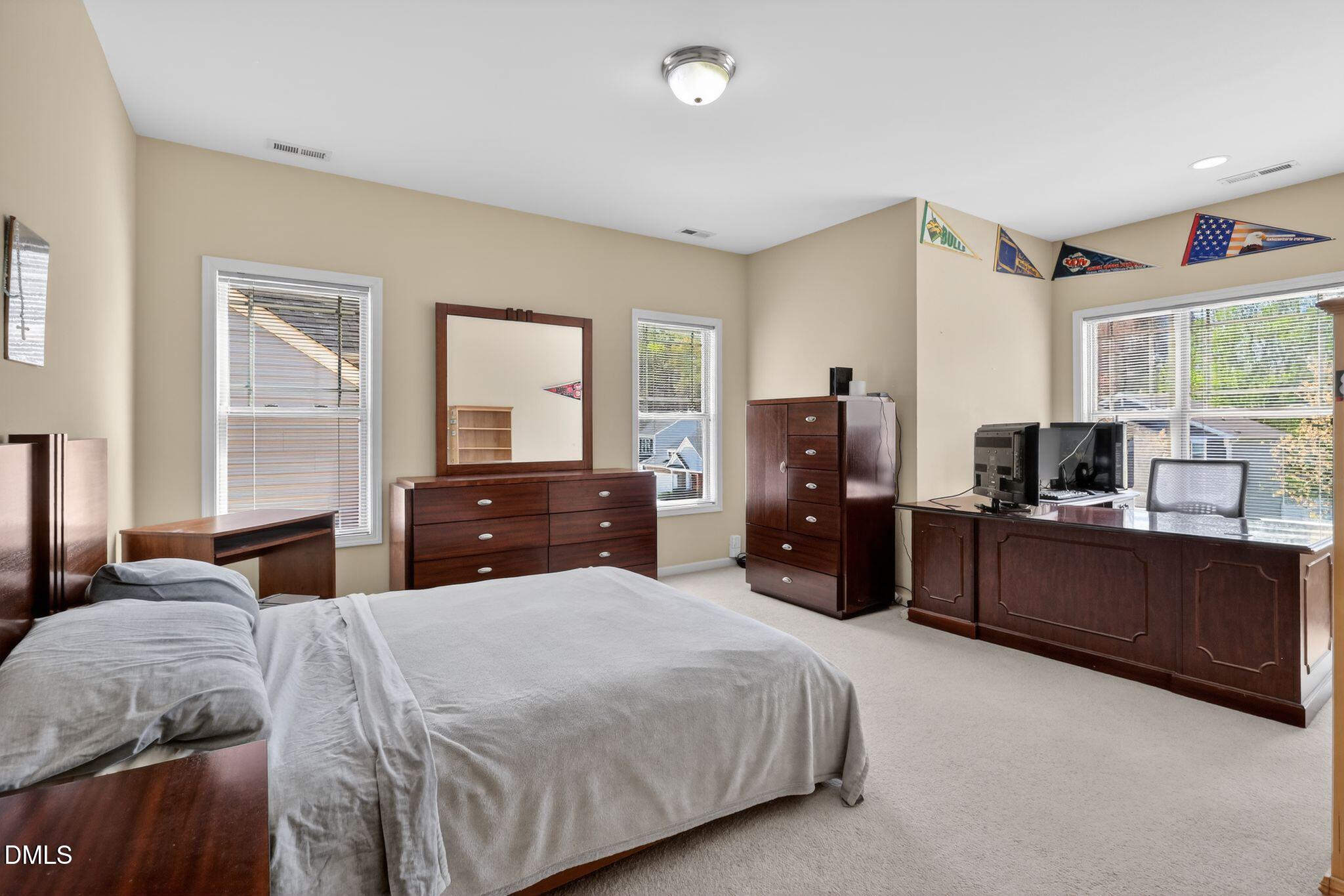 3428 Massey Pond Trail Raleigh, NC 27616 - Photo 26 of 39 a bedroom with a bed and large windows