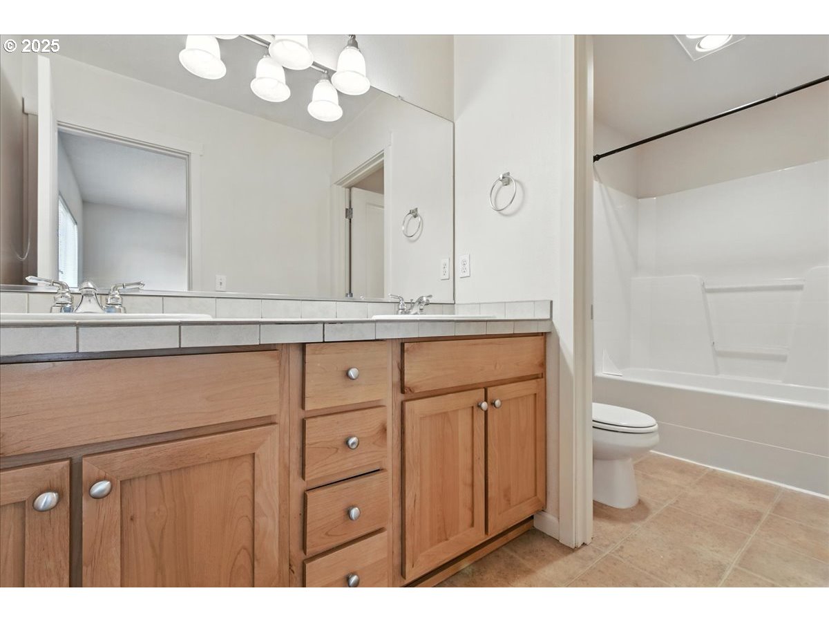 5927 Northeast 34th Street Vancouver, WA 98661 - Photo 20 of 29 a bathroom with a sink a toilet and a mirror