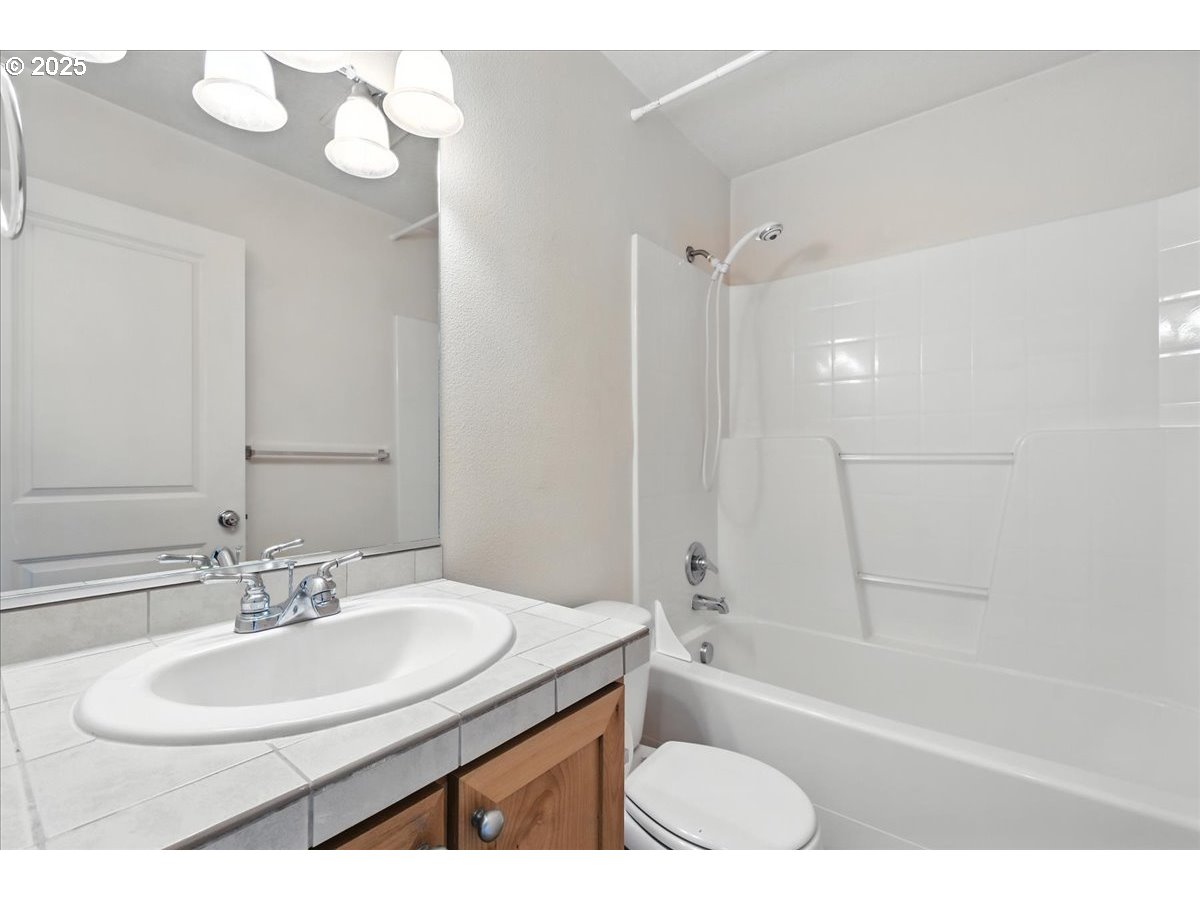 5927 Northeast 34th Street Vancouver, WA 98661 - Photo 23 of 29 a bathroom with a sink a toilet and bathtub
