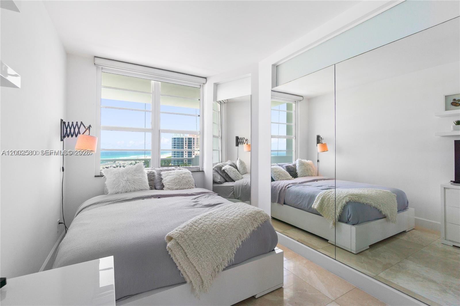 100 Lincoln Road, Unit 1046 Miami Beach, FL 33139 - Photo 12 of 18 a bedroom with two beds and large window