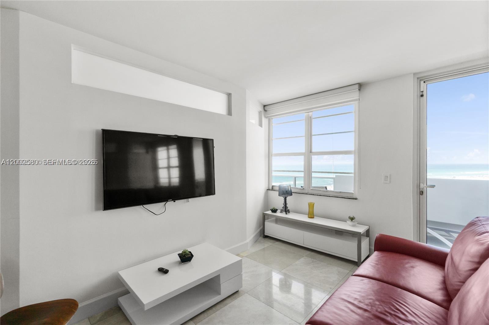 100 Lincoln Road, Unit 1046 Miami Beach, FL 33139 - Photo 3 of 18 a living room with furniture and a flat screen tv