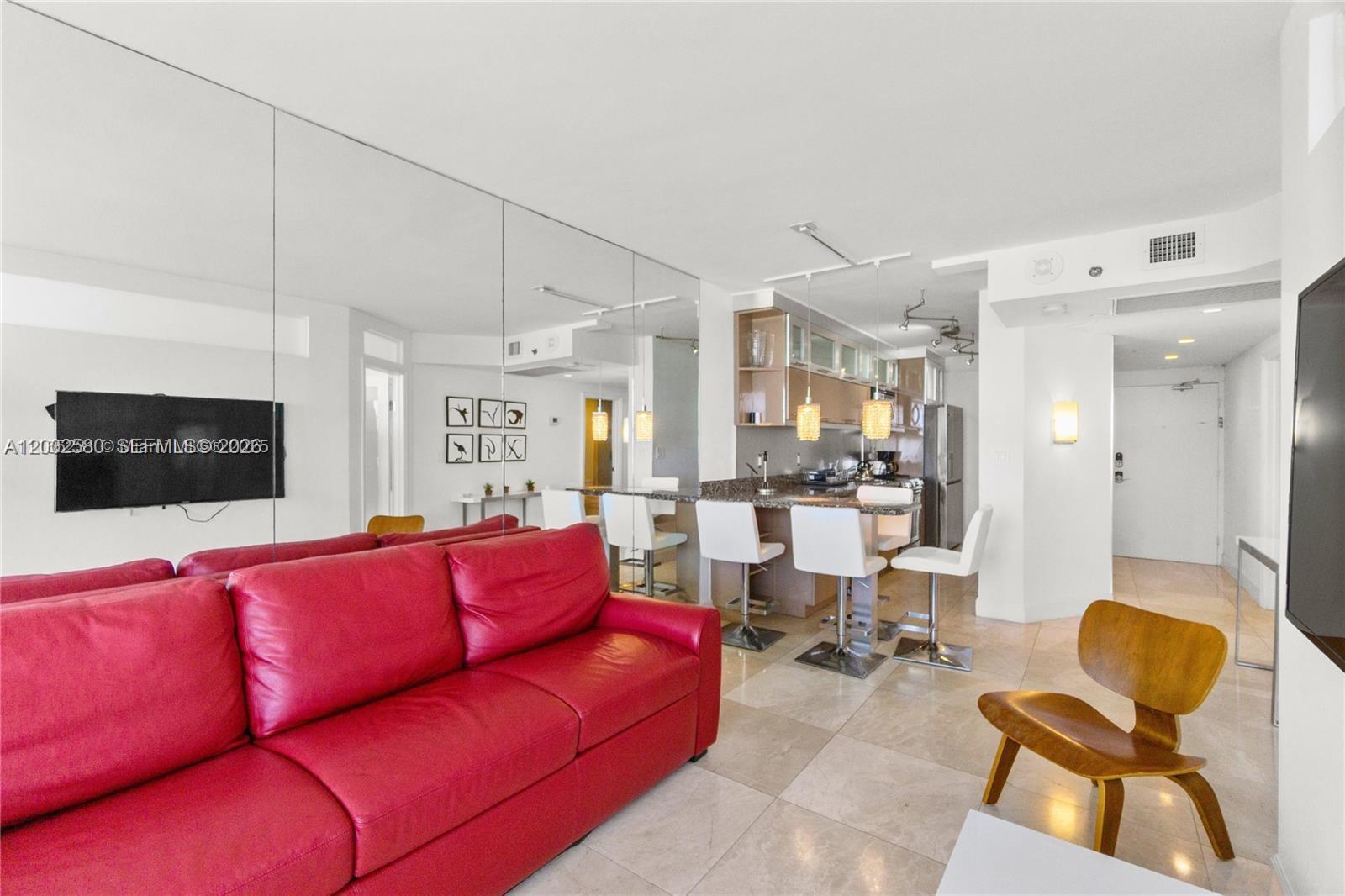 100 Lincoln Road, Unit 1046 Miami Beach, FL 33139 - Photo 7 of 18 a living room with furniture and a flat screen tv
