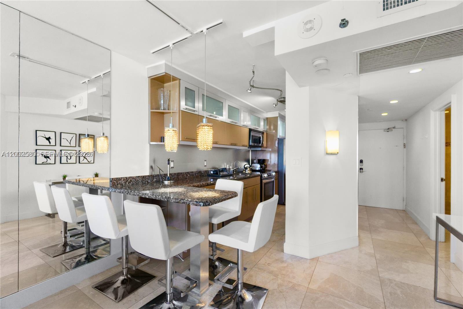 100 Lincoln Road, Unit 1046 Miami Beach, FL 33139 - Photo 8 of 18 a view of a dining room with furniture and a chandelier