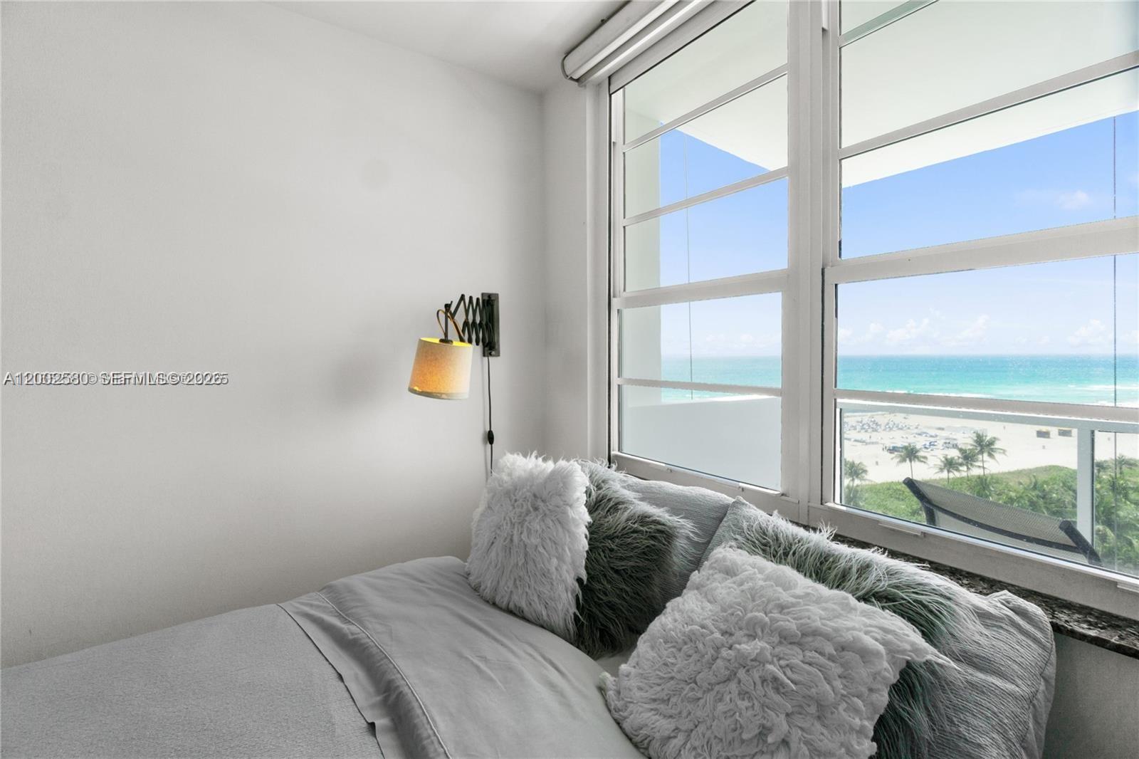100 Lincoln Road, Unit 1046 Miami Beach, FL 33139 - Photo 10 of 18 a bedroom with a bed and a large window