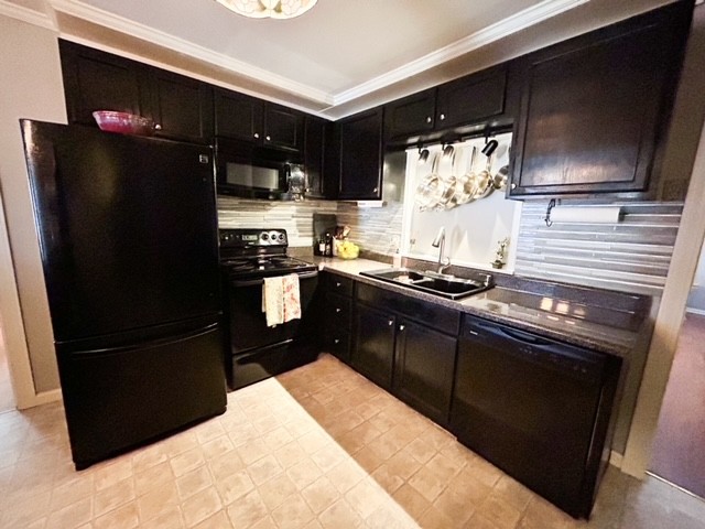 203 Glenhaven Road Paris, TN 38242 - Photo 14 of 42 a kitchen with a sink stainless steel appliances and cabinets