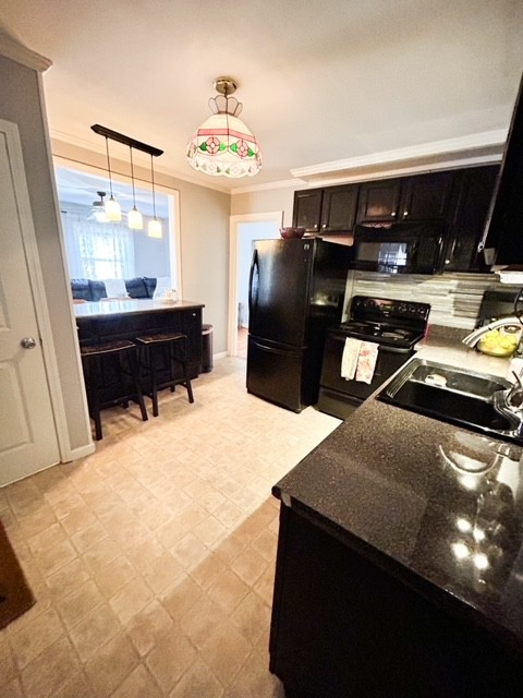 203 Glenhaven Road Paris, TN 38242 - Photo 16 of 42 a room with furniture and a flat screen tv