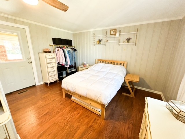 203 Glenhaven Road Paris, TN 38242 - Photo 18 of 42 a bedroom with a bed and wooden floor