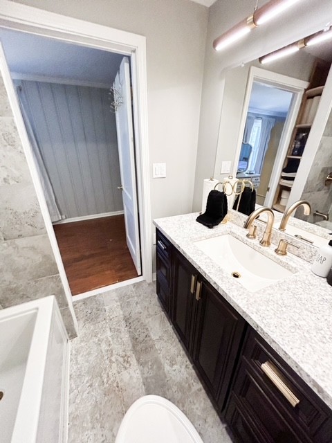 203 Glenhaven Road Paris, TN 38242 - Photo 22 of 42 a bathroom with a sink a toilet a mirror and vanity