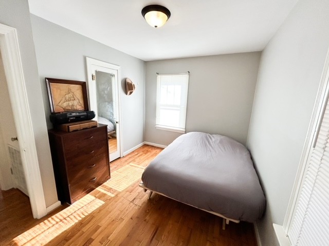 203 Glenhaven Road Paris, TN 38242 - Photo 6 of 42 a bedroom with a bed and wooden floor