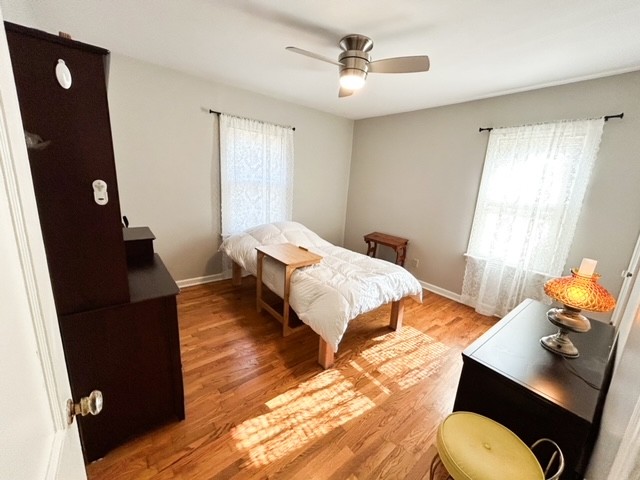 203 Glenhaven Road Paris, TN 38242 - Photo 7 of 42 a bedroom with a bed and wooden floor