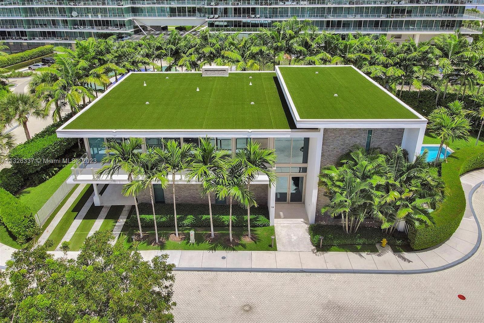 112 Reef Lane Key Biscayne, FL 33149 - Photo 1 of 41 an aerial view of a tennis ground and a large pool table and chairs
