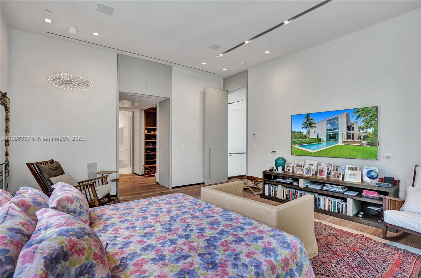 112 Reef Lane Key Biscayne, FL 33149 - Photo 13 of 41 a bedroom with a bed and wooden floor