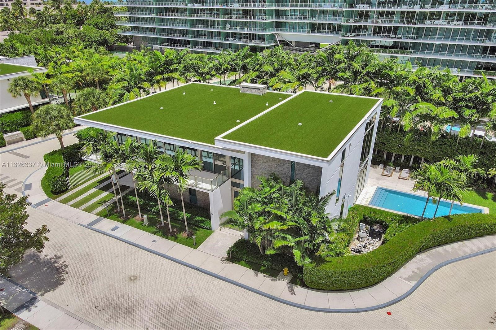 112 Reef Lane Key Biscayne, FL 33149 - Photo 2 of 41 a view of a tennis court with a flower garden