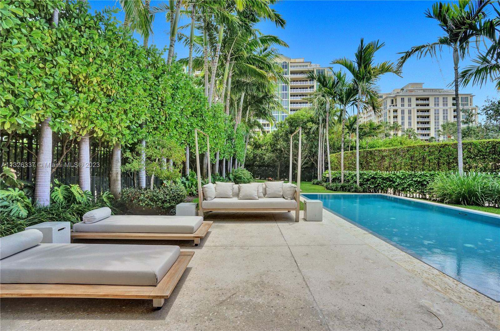 112 Reef Lane Key Biscayne, FL 33149 - Photo 29 of 41 a view of a house with patio and a garden