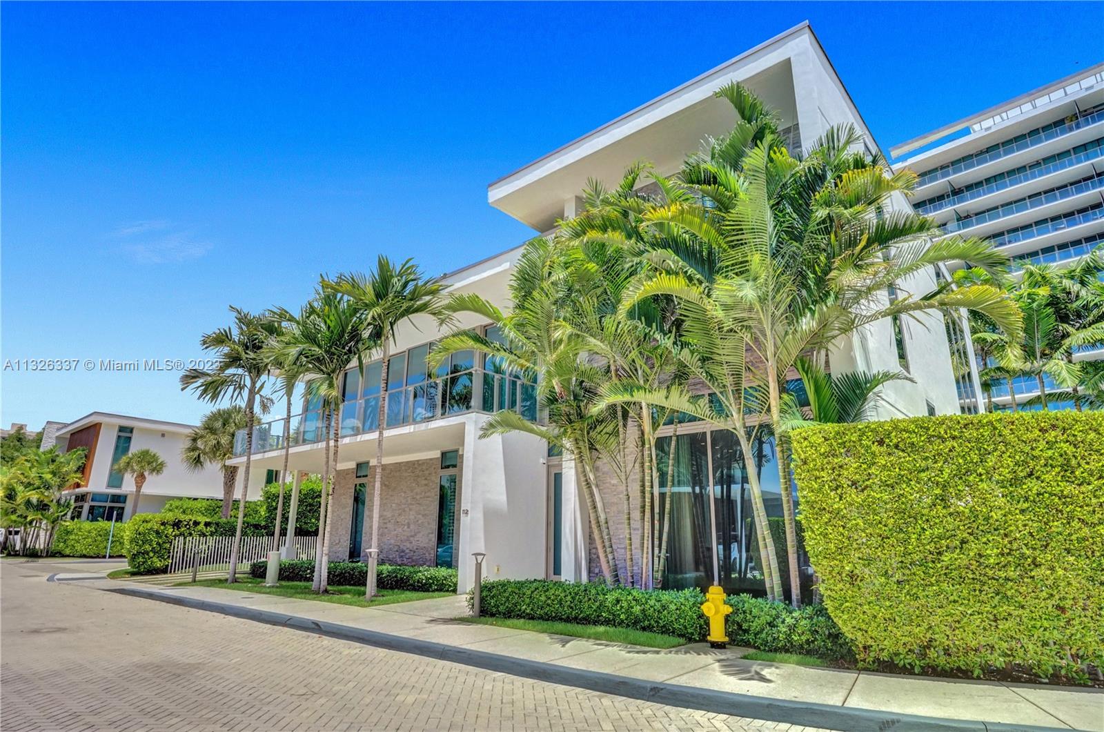 112 Reef Lane Key Biscayne, FL 33149 - Photo 34 of 41 a front view of a house with a garden
