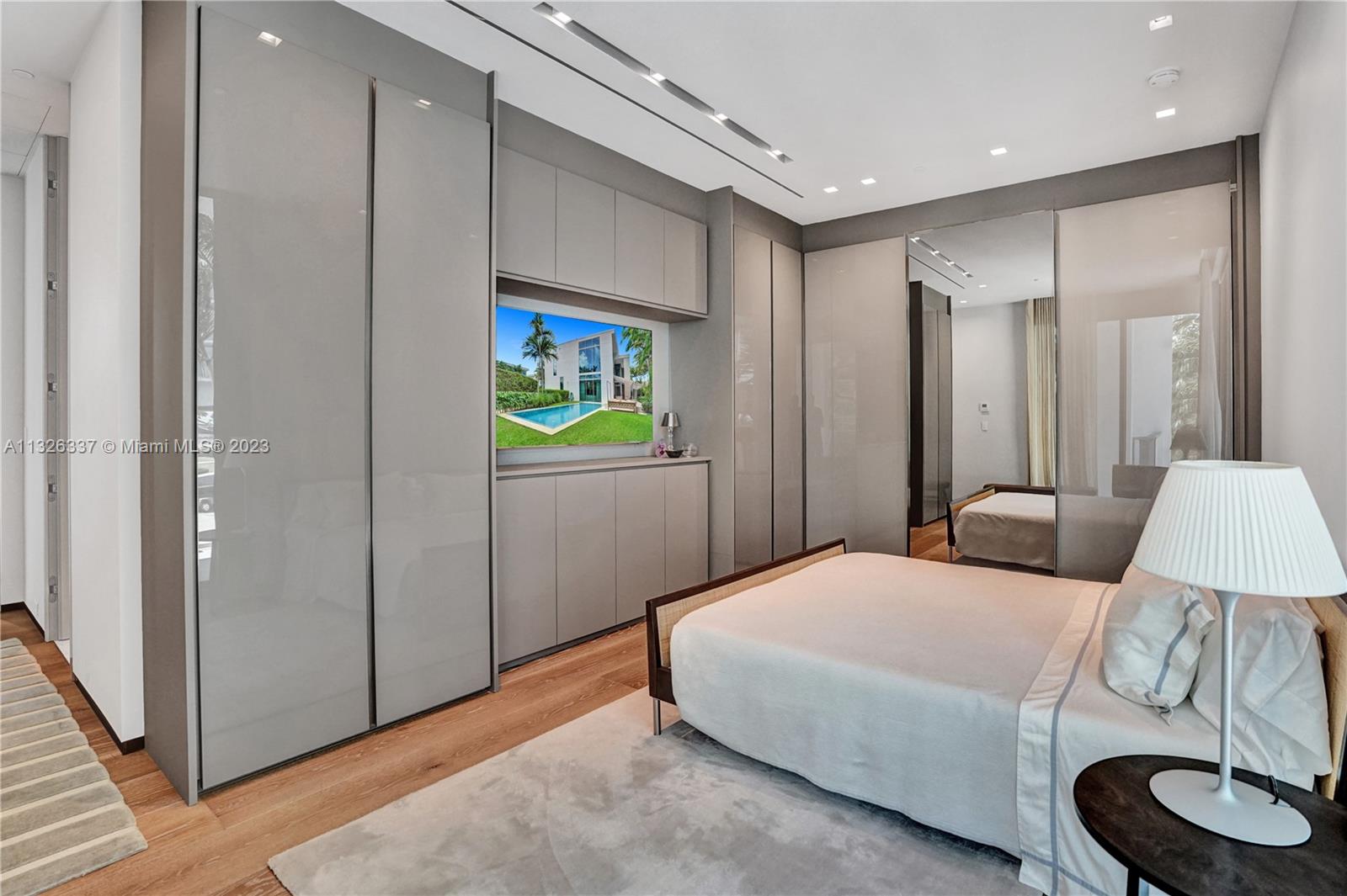 112 Reef Lane Key Biscayne, FL 33149 - Photo 5 of 41 a bedroom with a bed and a lamp