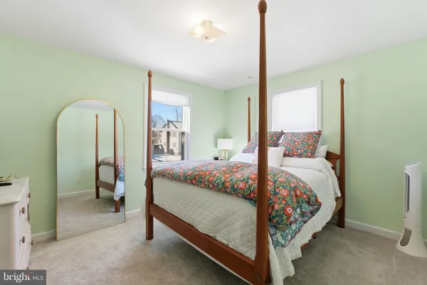 a bed sitting in a bedroom next to a window