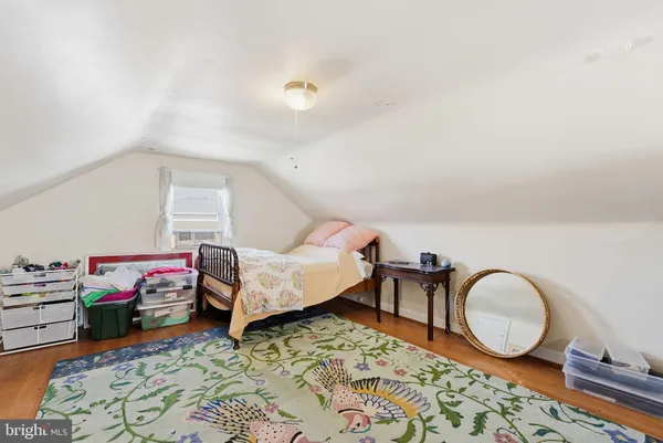 a bedroom with furniture and a rug
