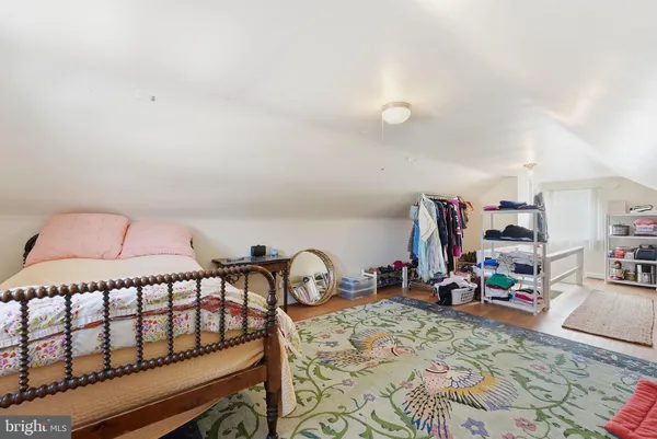 a bedroom with furniture and a wooden floor