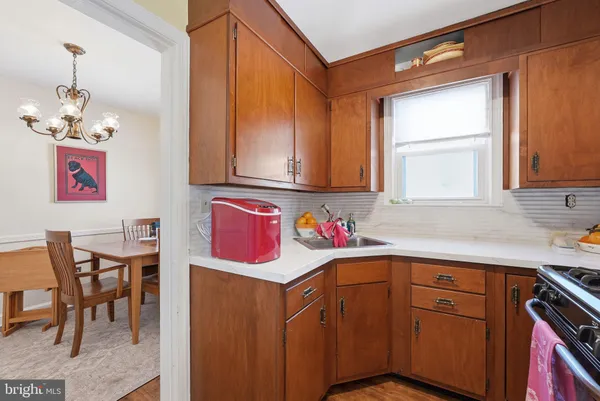 a kitchen with a sink cabinets and window