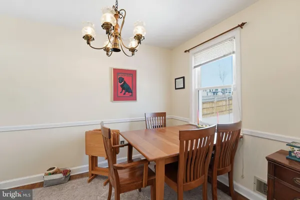 a view of a dining room with furniture wooden floor and a window