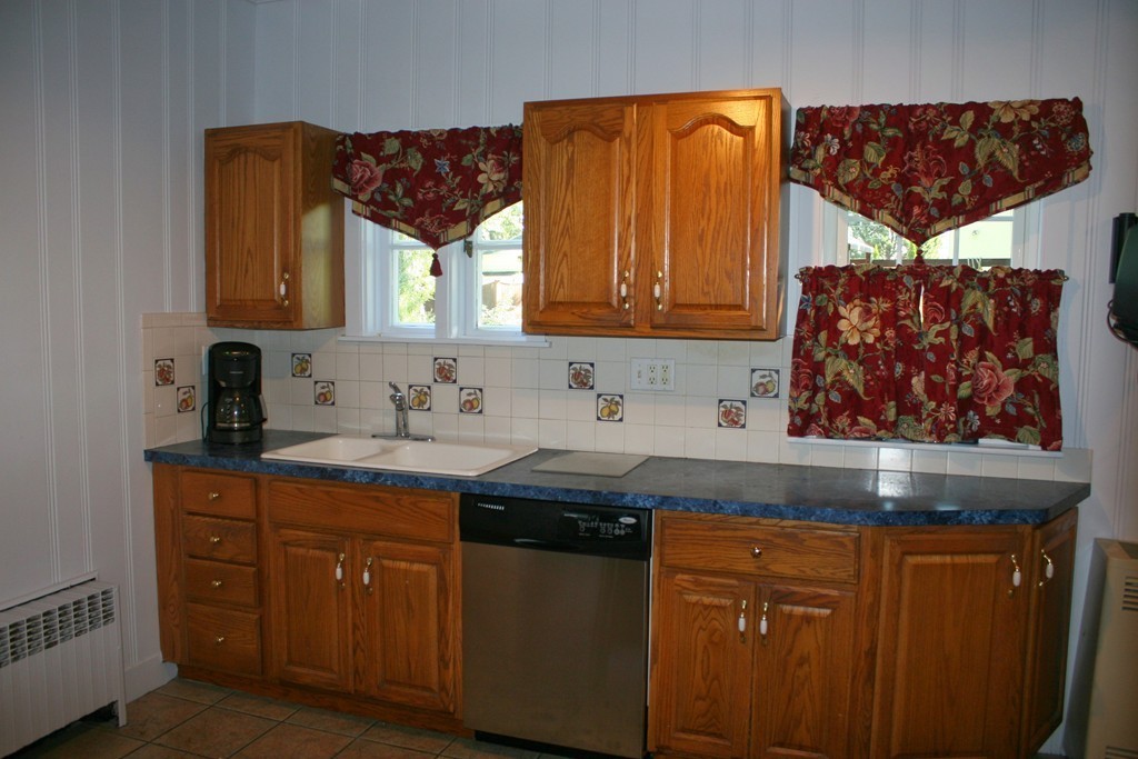 104 Shefford Street Springfield, MA 01107 - Photo 11 of 18 a kitchen with granite countertop a sink a stove and cabinets