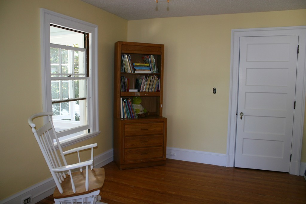 104 Shefford Street Springfield, MA 01107 - Photo 16 of 18 a view of an empty room with wooden floor and a window