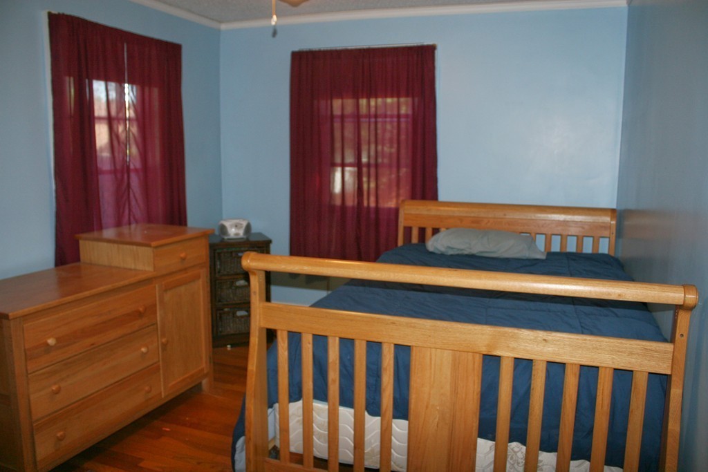 104 Shefford Street Springfield, MA 01107 - Photo 18 of 18 a bedroom with a bed and wooden floor