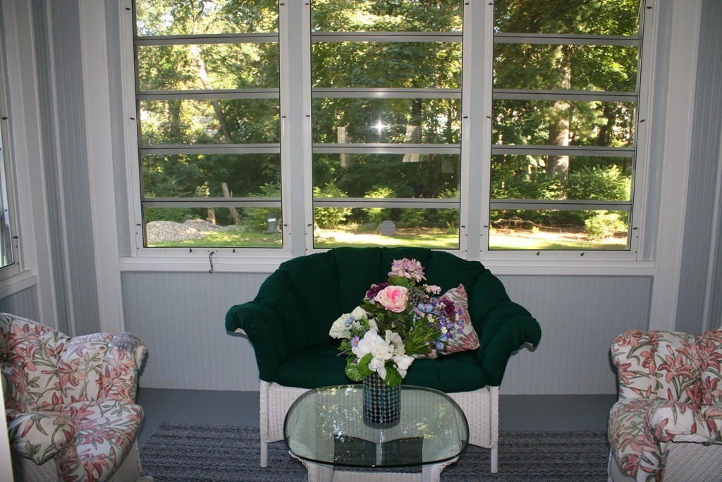 104 Shefford Street Springfield, MA 01107 - Photo 5 of 18 a vase of flowers sitting on a table with a window