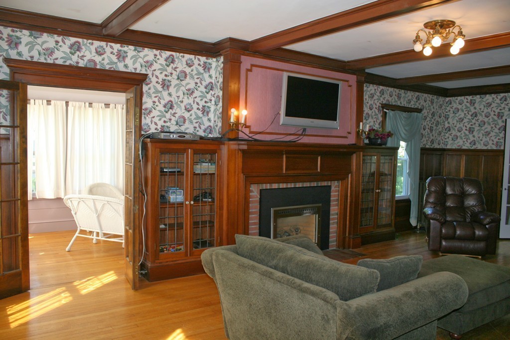 104 Shefford Street Springfield, MA 01107 - Photo 9 of 18 a living room with furniture a flat screen tv and a fireplace