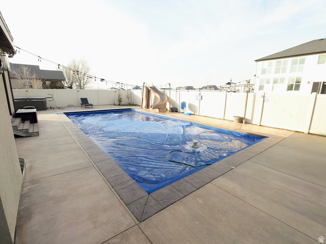 552 Sunset Crest Way Draper, UT 84020 - Photo 60 of 68 View of swimming pool with a water slide, a fenced backyard, and a patio