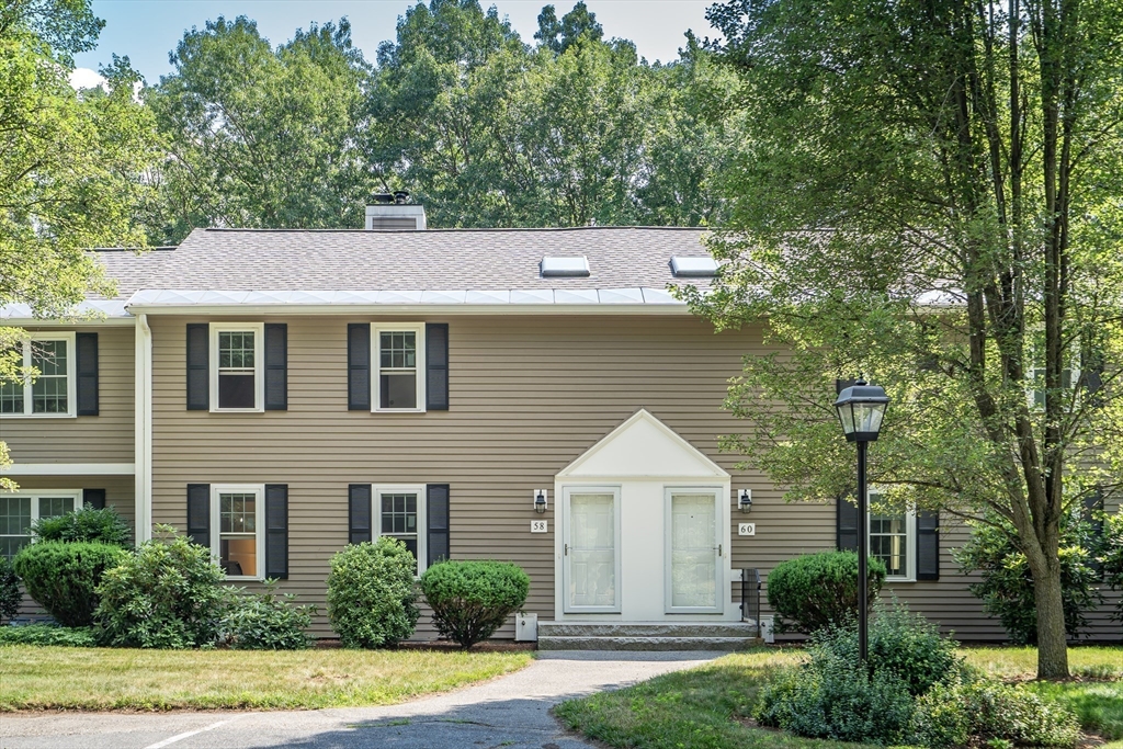 58 MacIntosh Lane, Unit 58 Boxborough, MA 01719 - Photo 2 of 23 a front view of a house with a yard and trees