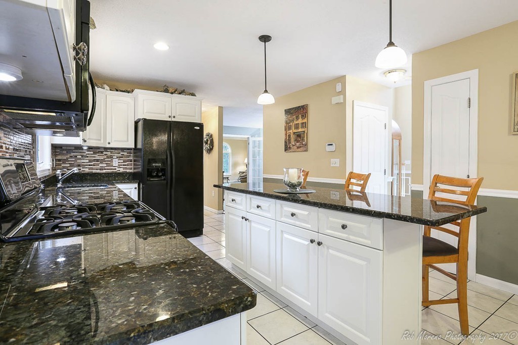 9 Garrison Road Dracut, MA 01826 - Photo 11 of 30 a kitchen with refrigerator a stove a sink and a refrigerator