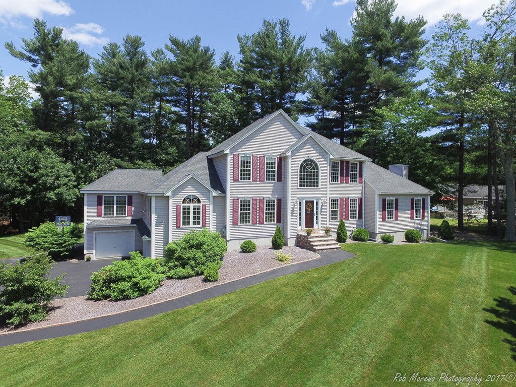 9 Garrison Road Dracut, MA 01826 - Photo 3 of 30 a front view of a house with a garden and trees