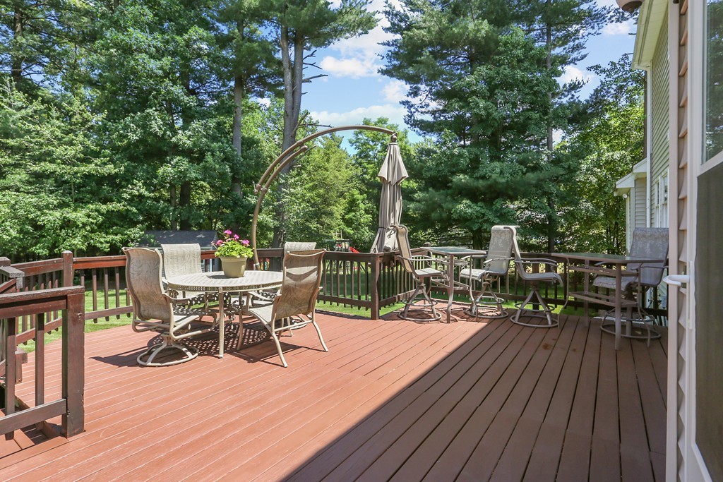 9 Garrison Road Dracut, MA 01826 - Photo 7 of 30 a view of a chairs and table on the wooden deck