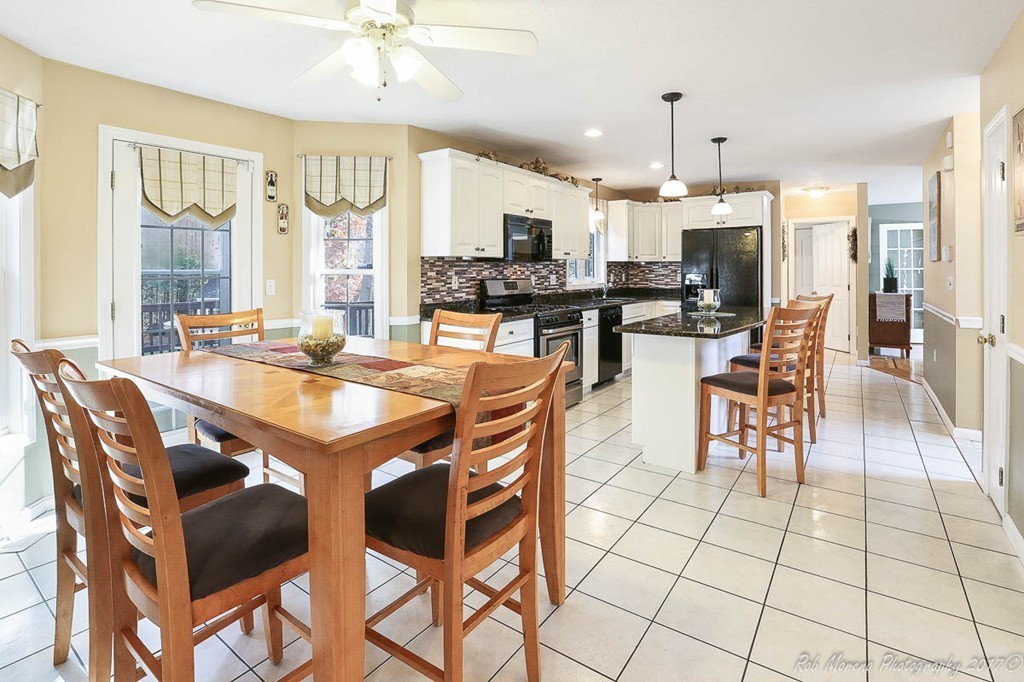 9 Garrison Road Dracut, MA 01826 - Photo 9 of 30 a dining hall with stainless steel appliances a dining table and chairs