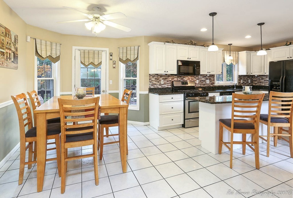 9 Garrison Road Dracut, MA 01826 - Photo 10 of 30 a large kitchen with a table and chairs