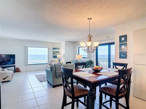 a bathroom with a toilet a sink a mirror and a window