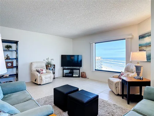 a living room with furniture a rug and a window